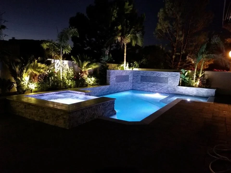 Illuminated pool and spa at night
