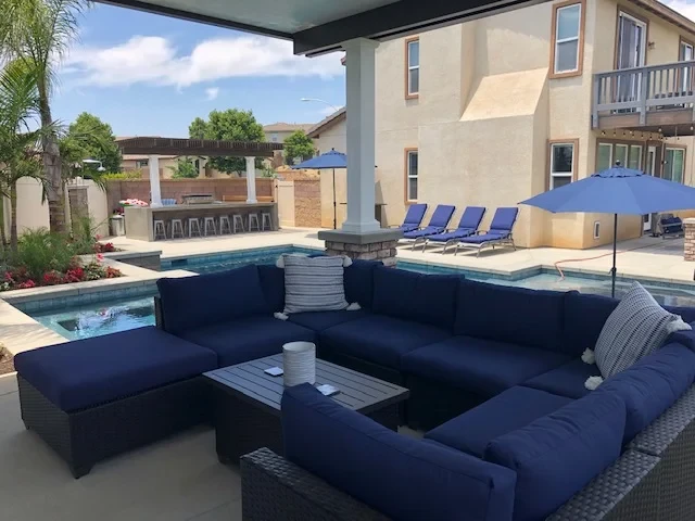 Backyard patio with pool and seating